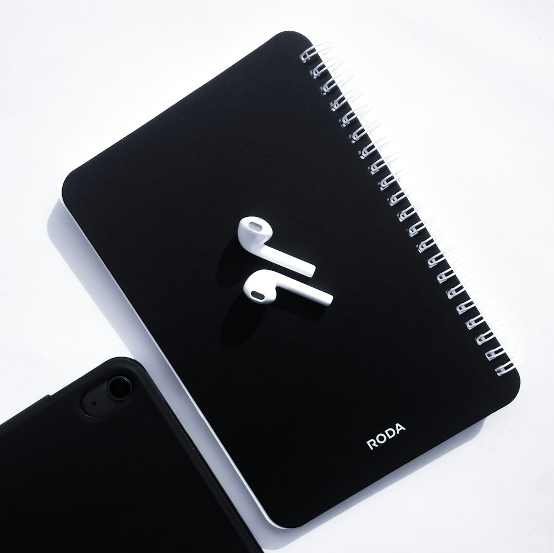 Notebook, pen and documents on a light desk