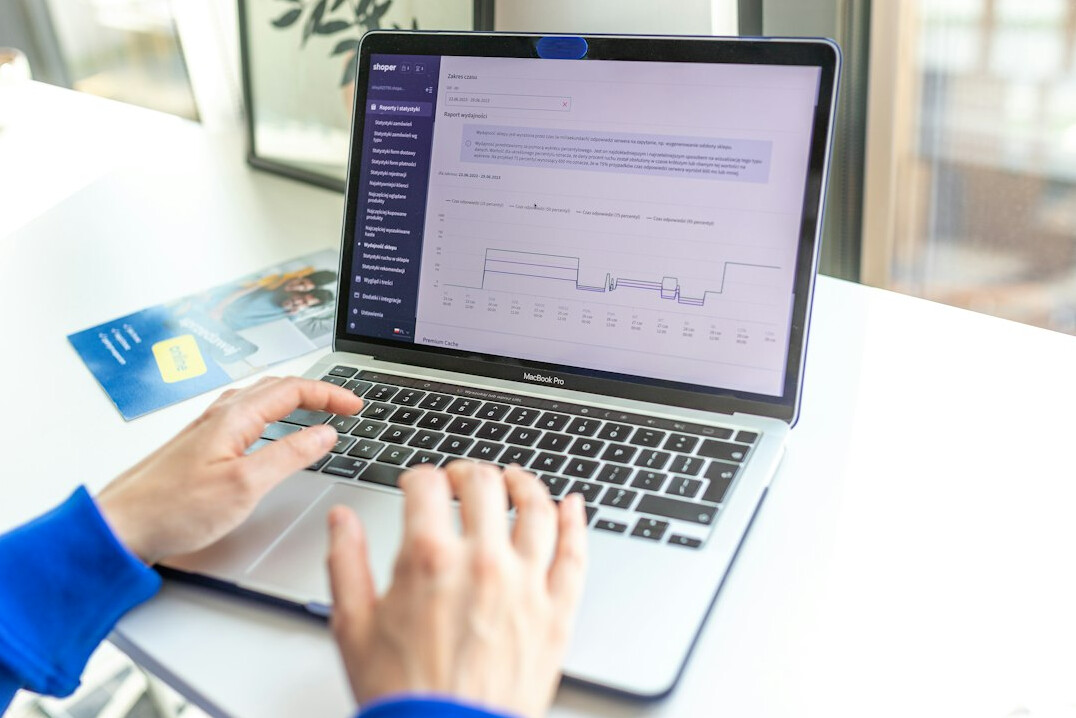 person tracking finances on laptop