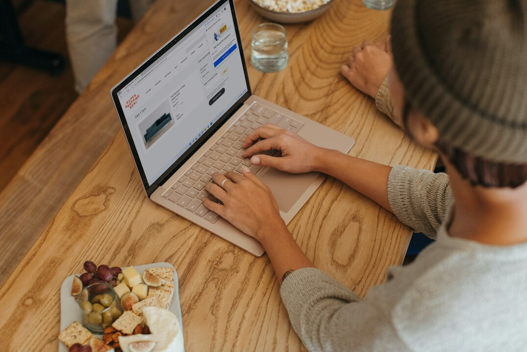 person tracking finances on laptop