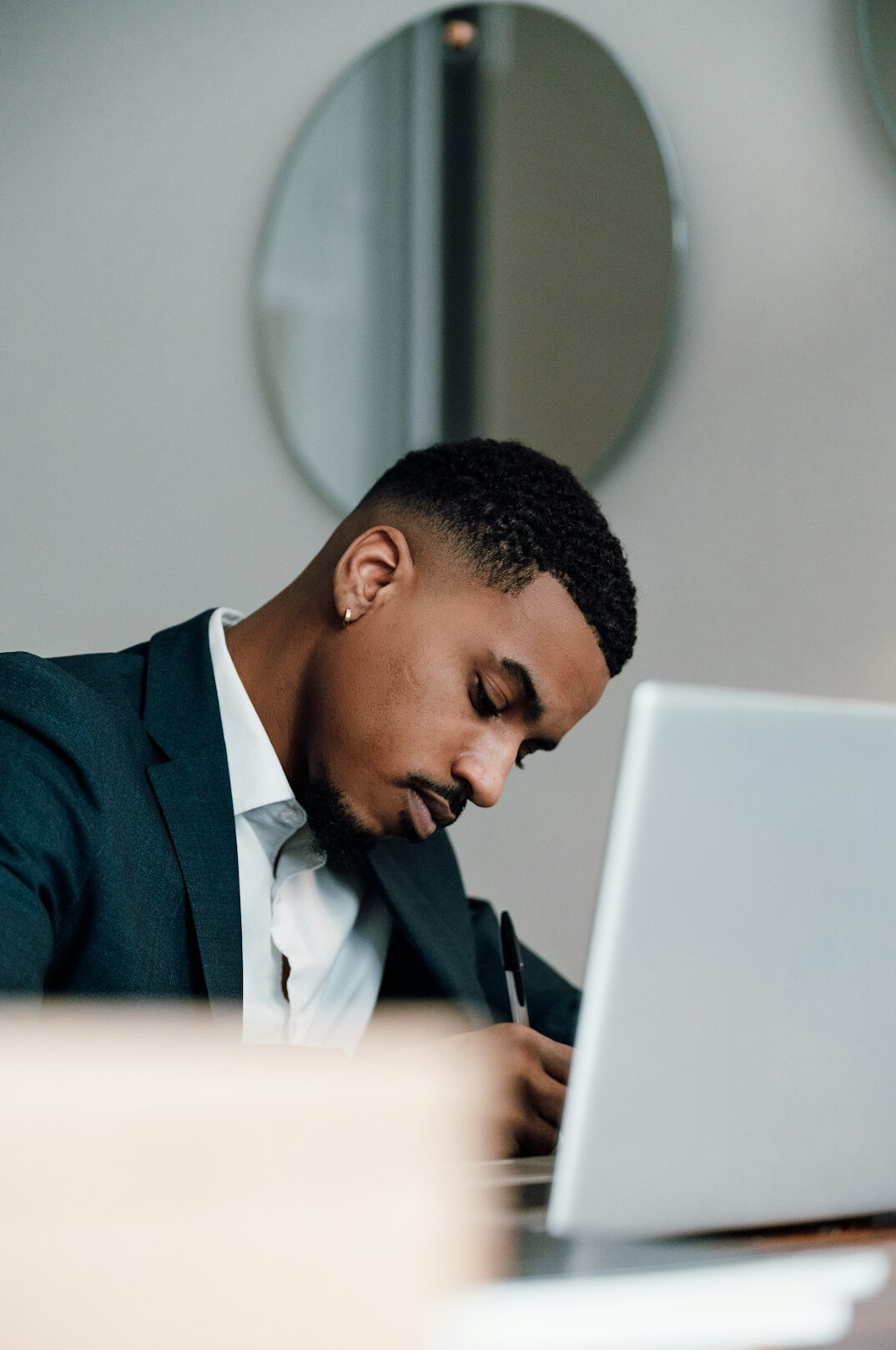 busy professional checking budget on laptop