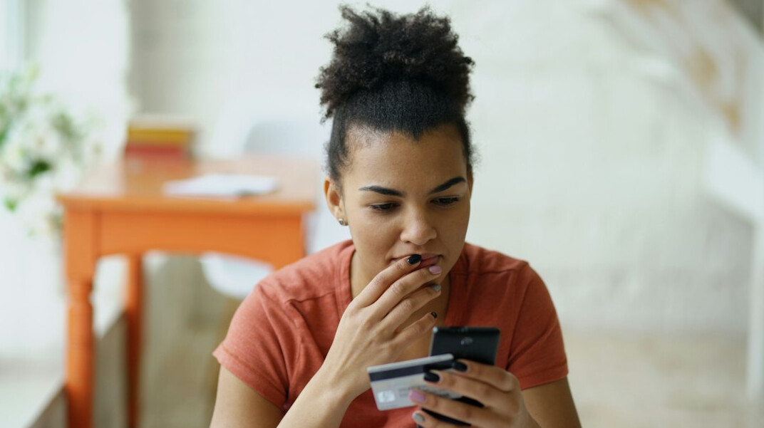 woman reviewing expenses on phone