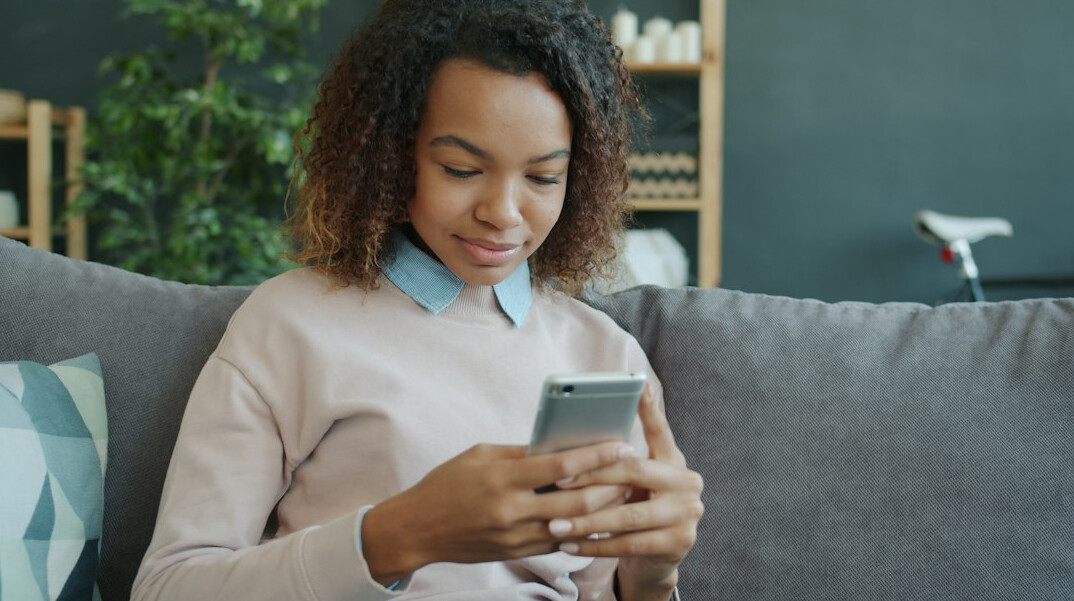 woman reviewing budget on smartphone