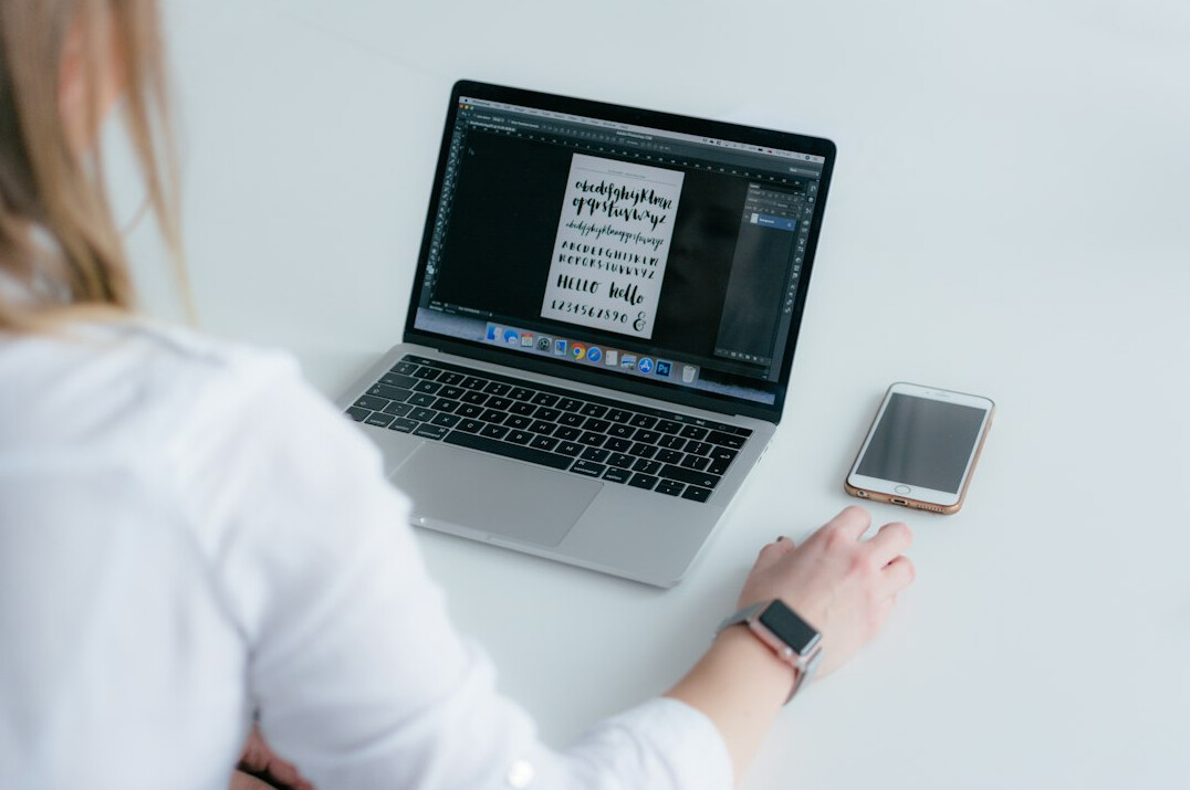 woman using finance app on laptop