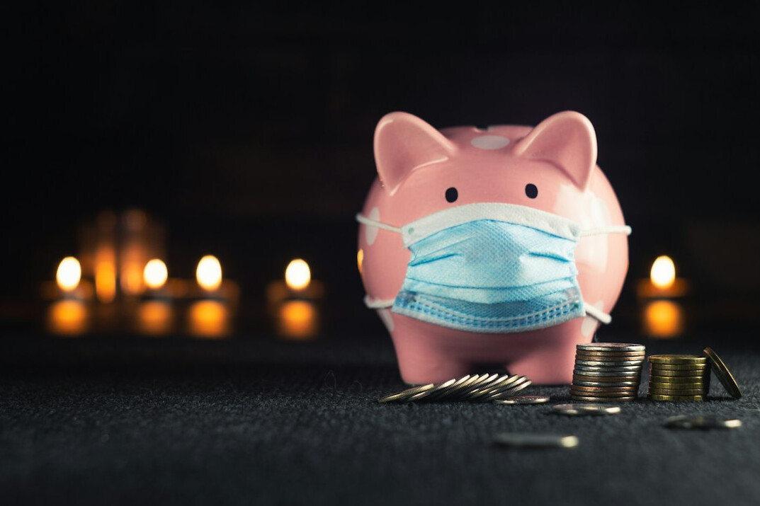 person saving money in piggy bank